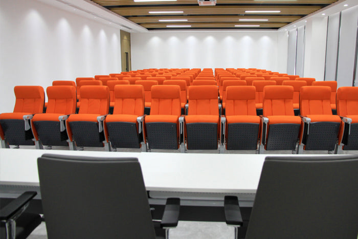 Modern conference room with orange and black chairs