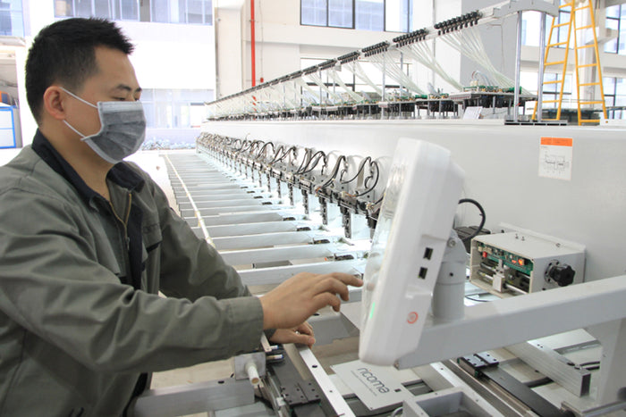 Person working with industrial equipment in a factory setting