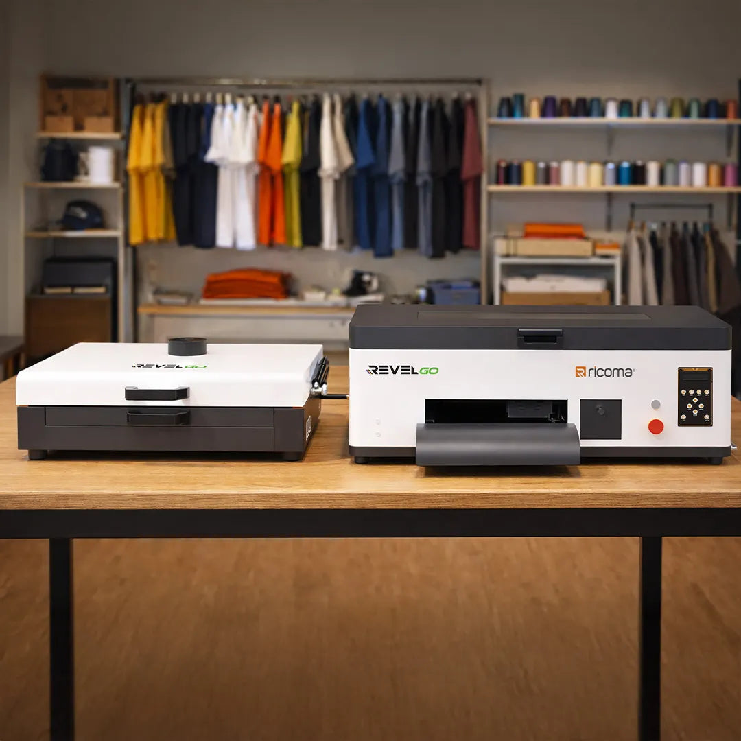 Revel Go portable DTF printer and powder shaker on workspace table for custom apparel printing
